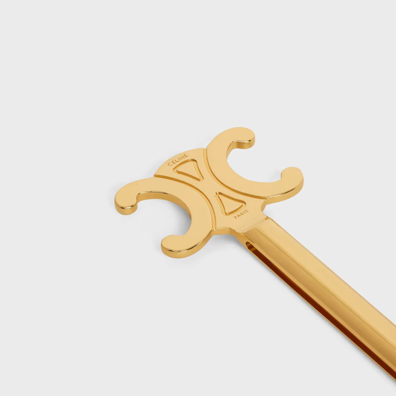 Close-up detail of iconic Triomphe logo on glamorous luxury lifestyle items 2026