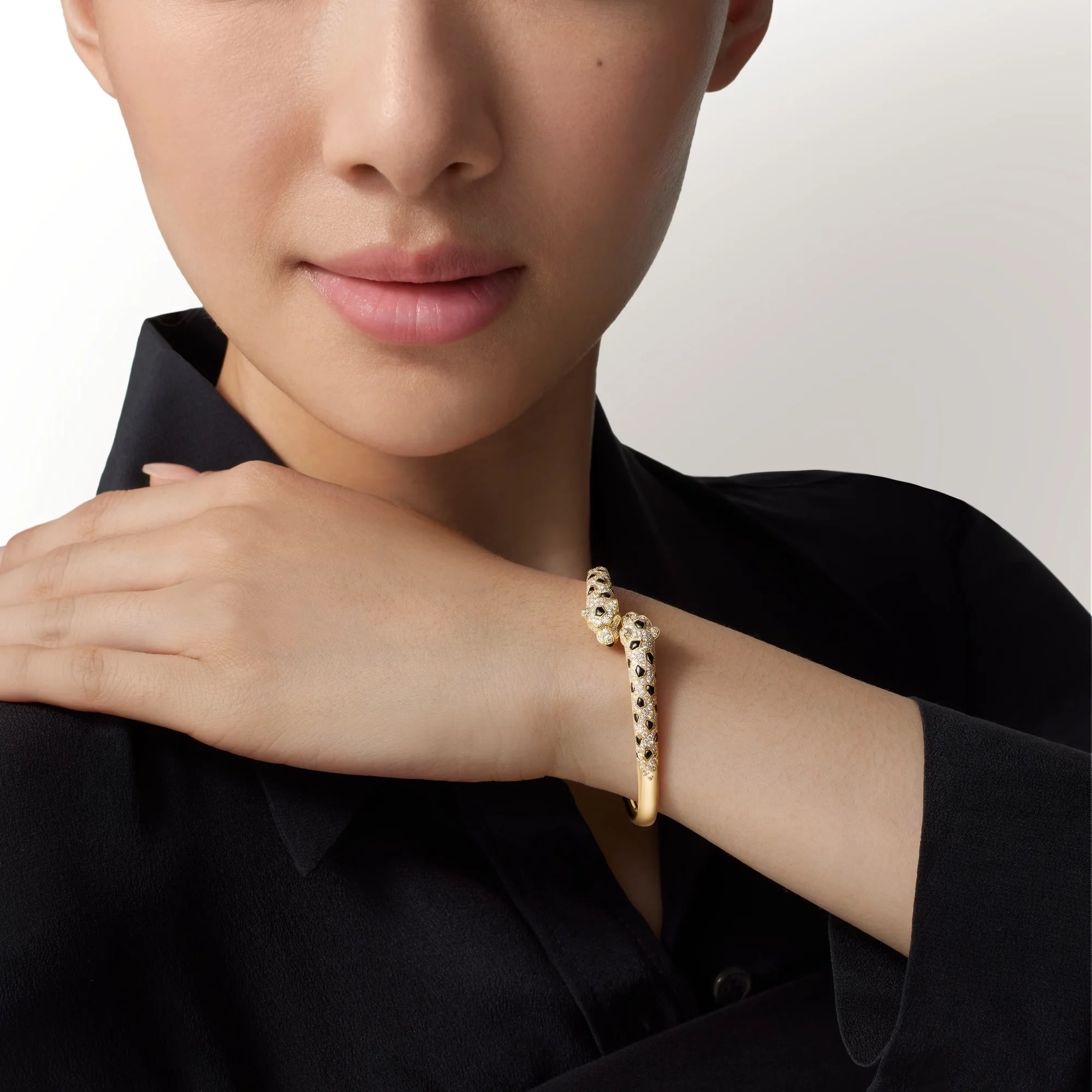 Cartier Love and Panthère bracelets with Rolex Day-Date Rose Gold watch.