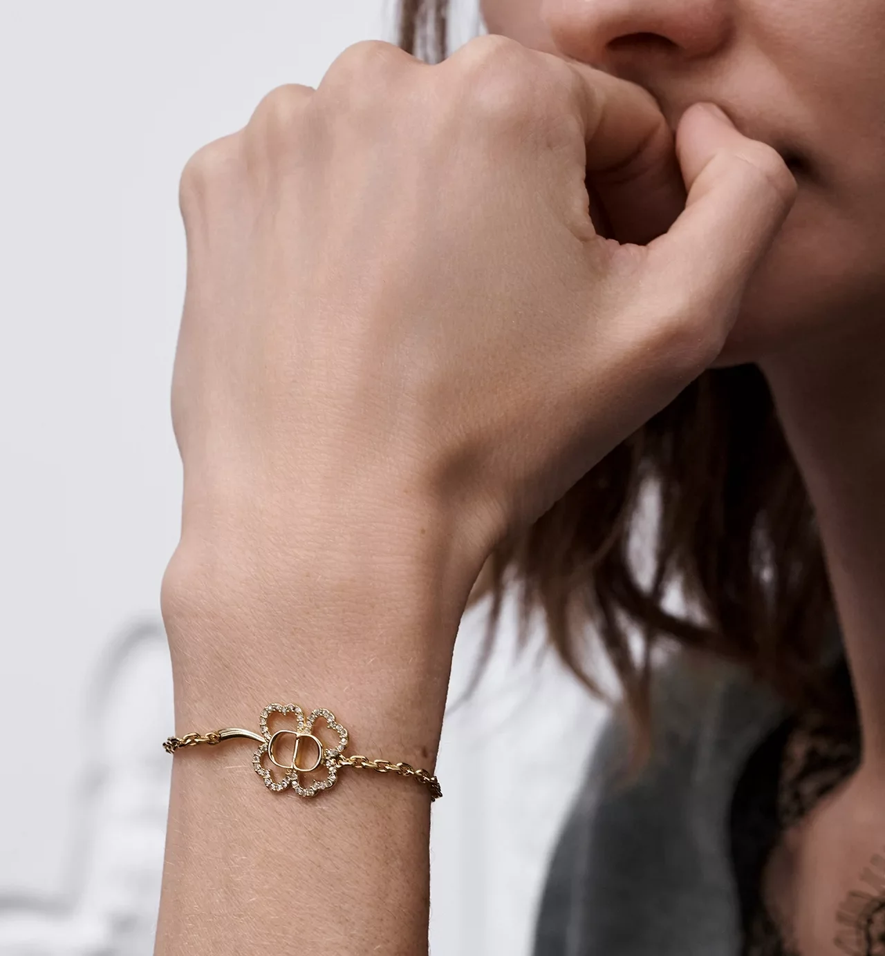 Luxury fashion lifestyle styling featuring Dior Night Code and CD Shiny Clover bracelets